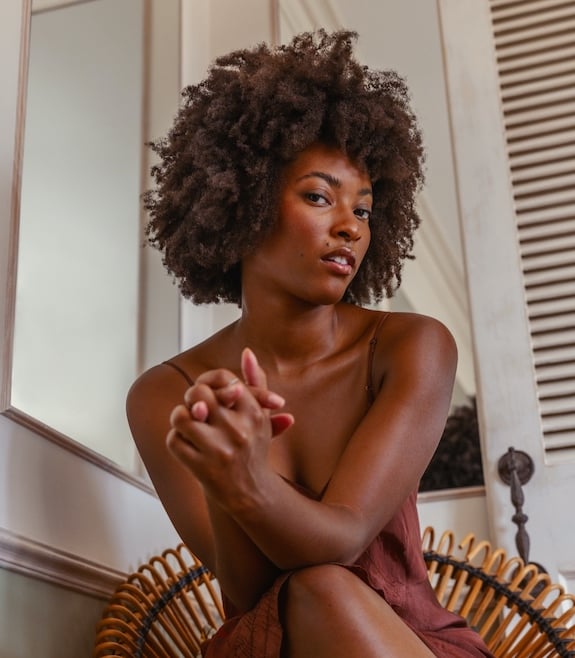 Woman with healthy looking and naturally curly black hair