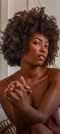 Woman with healthy looking and naturally curly black hair