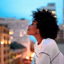 Woman with healthy looking and naturally curly black hair